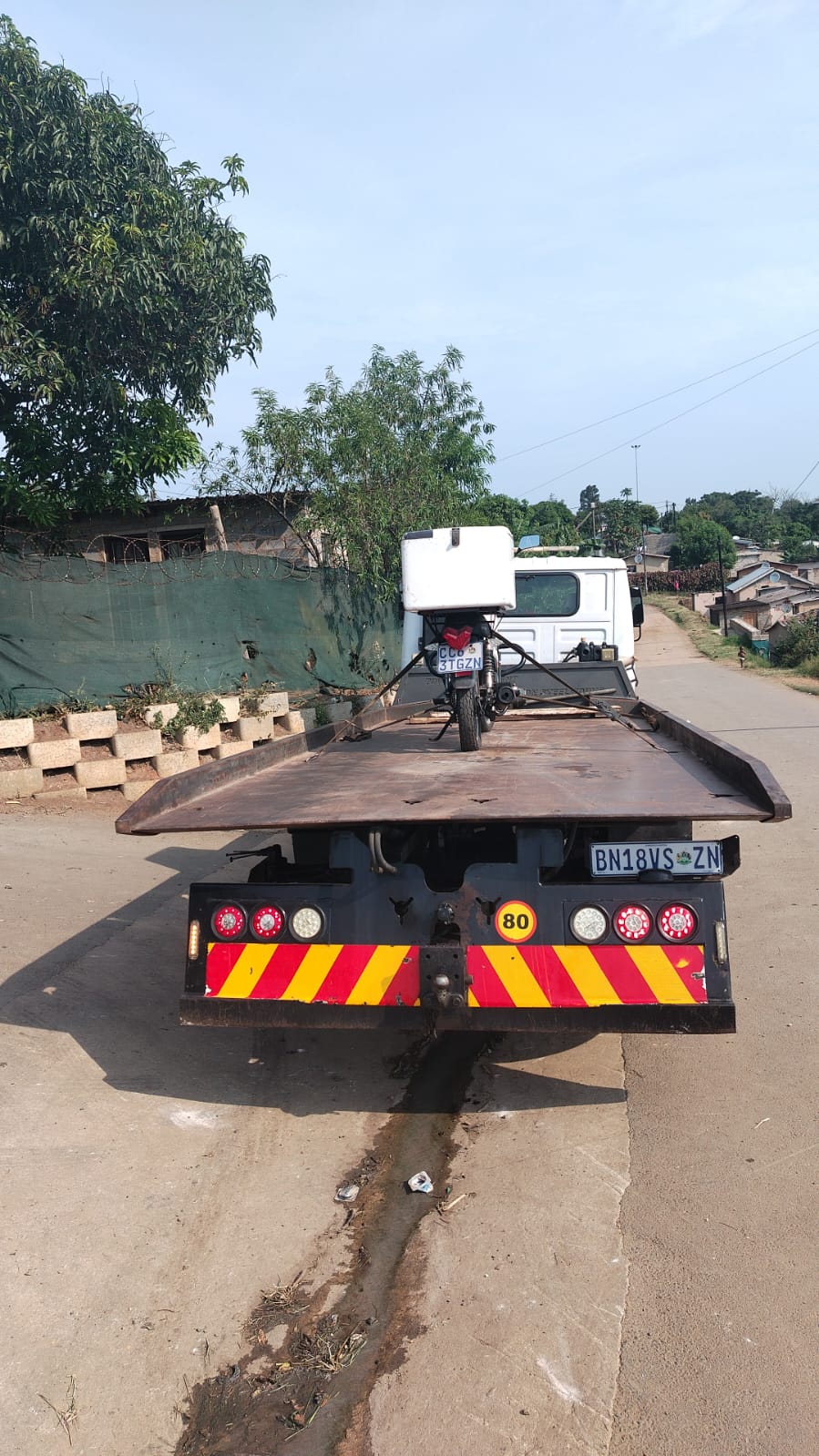 Motorcycle secured on a flatbed tow truck