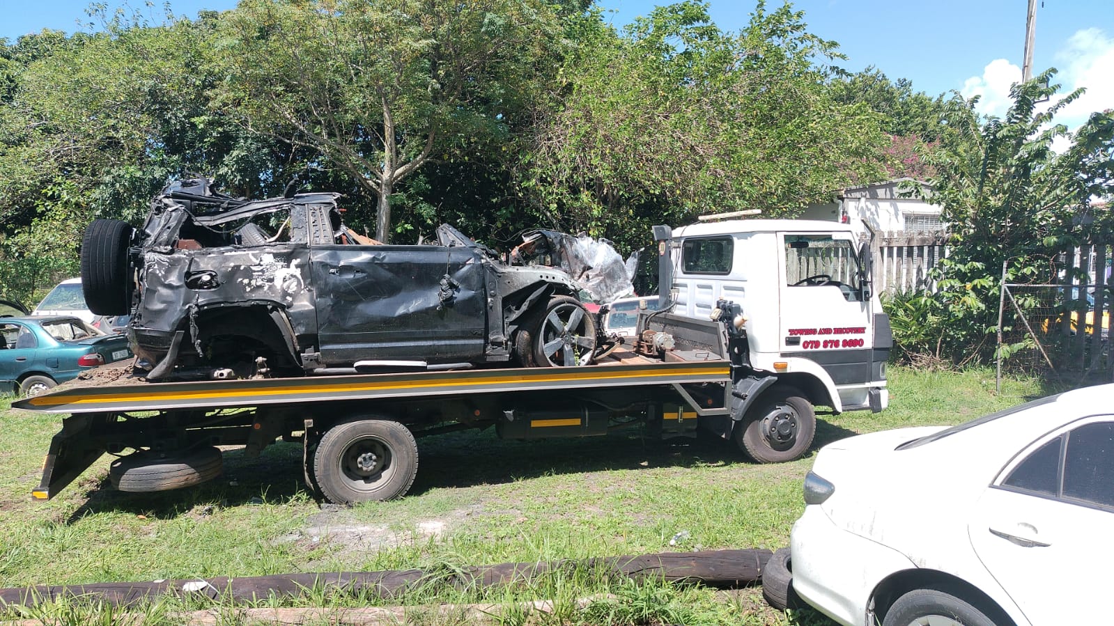 Severely damaged SUV recovered on a flatbed tow truck
